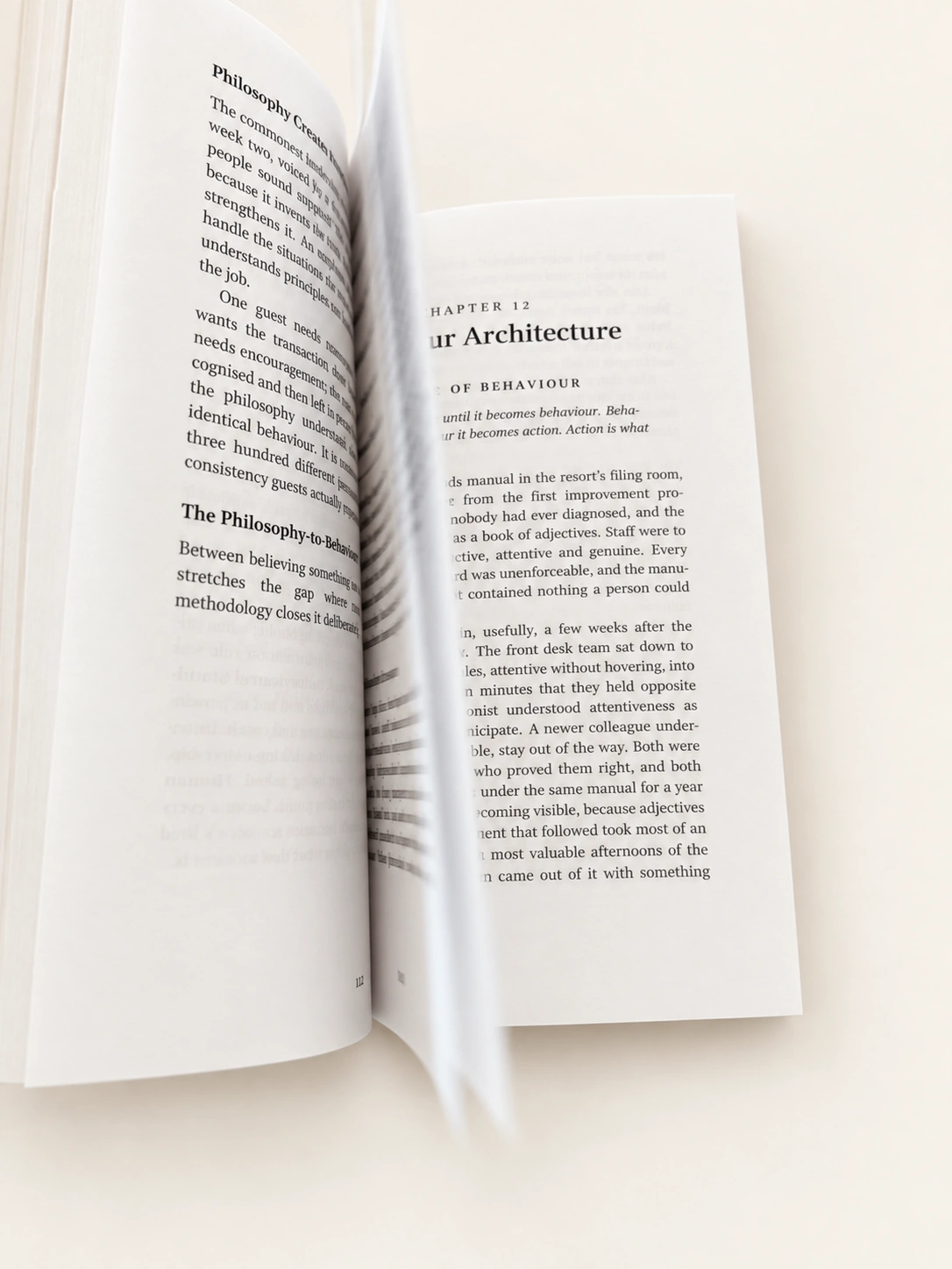 An open copy of The 26 Laws with a page turning