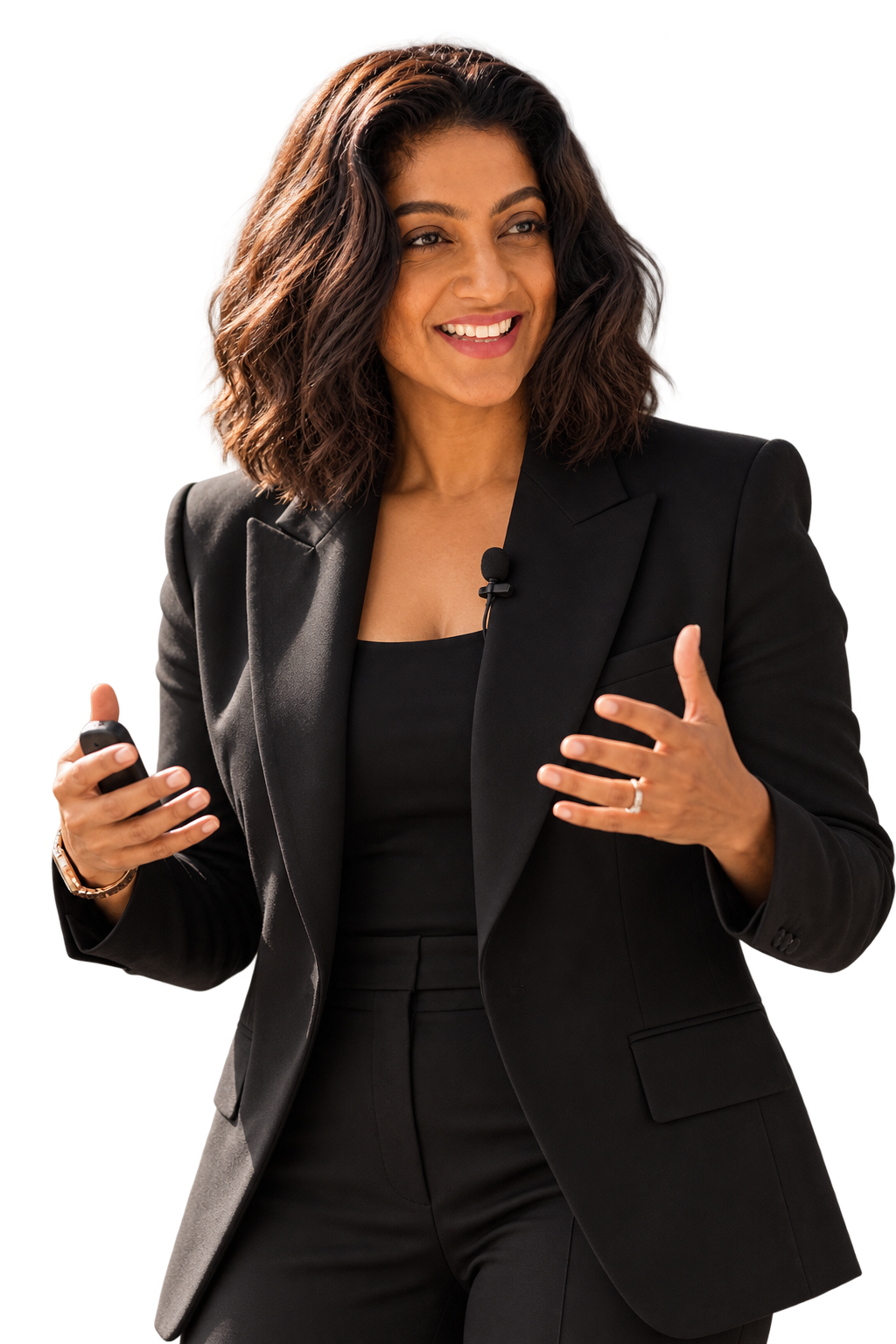 Nerissa speaking in a black suit, holding a presentation remote and gesturing